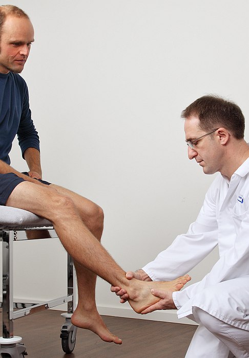 Examination of the foot and ankle by the orthopaedist.