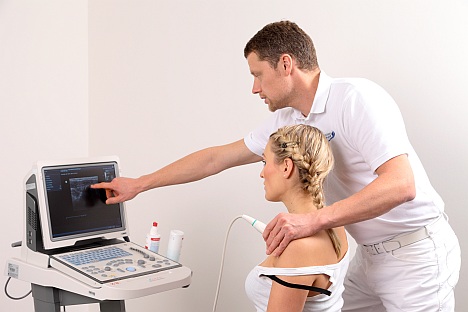 Shoulder specialist examining the shoulder joint